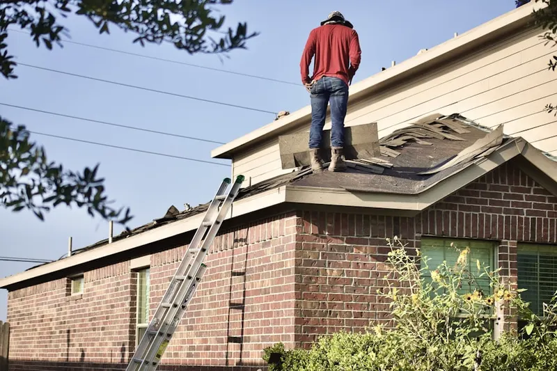 Professional roofer working on a residential roof in Northwest Central Loveland